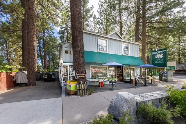 a view of patio with a table and chairs under an umbrella