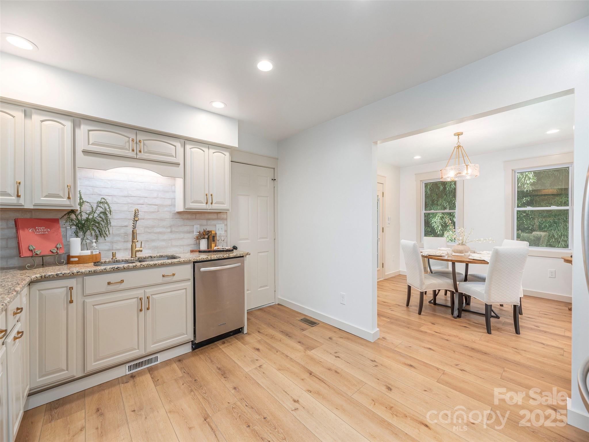 93 Cresthaven Drive Clyde, NC 28721 - Photo 12 of 27 a kitchen with a sink cabinets and wooden floor