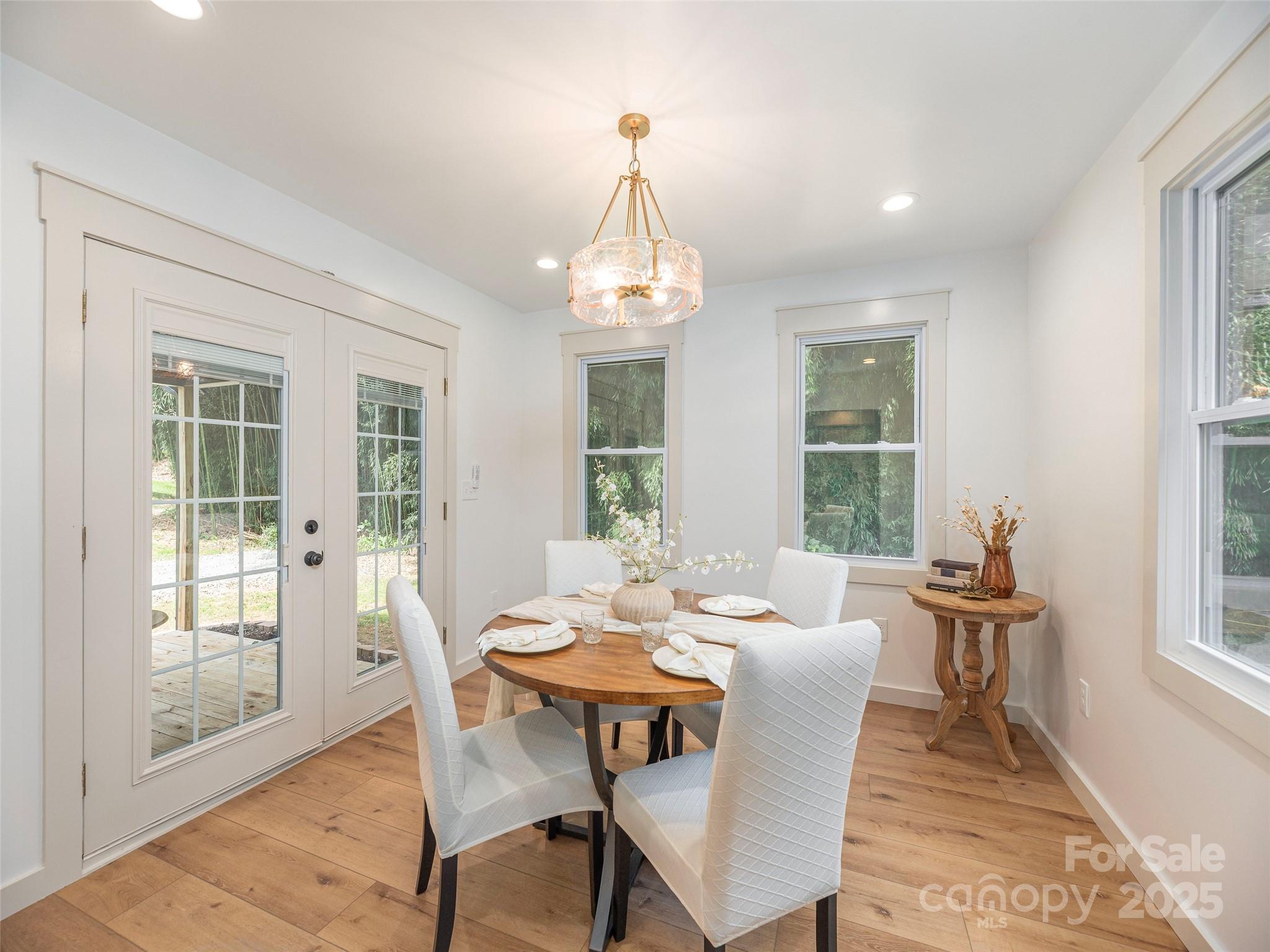 93 Cresthaven Drive Clyde, NC 28721 - Photo 15 of 27 a dining room with furniture a chandelier and wooden floor