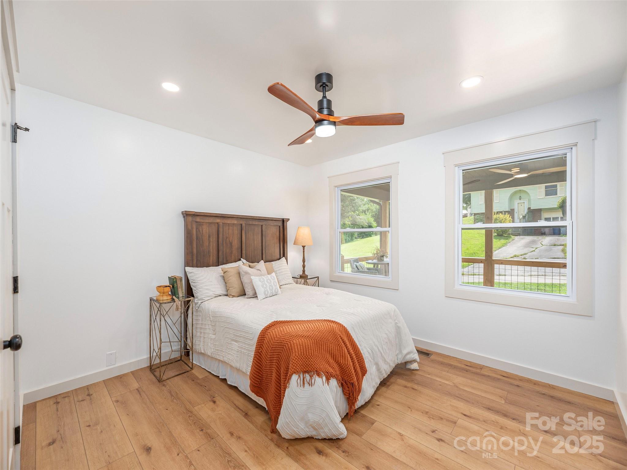 93 Cresthaven Drive Clyde, NC 28721 - Photo 16 of 27 a bedroom with a bed and wooden floor