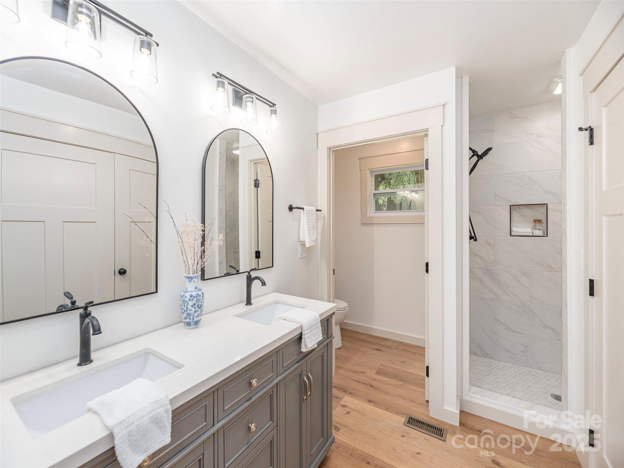 93 Cresthaven Drive Clyde, NC 28721 - Photo 17 of 27 a bathroom with a double vanity sink mirror and shower