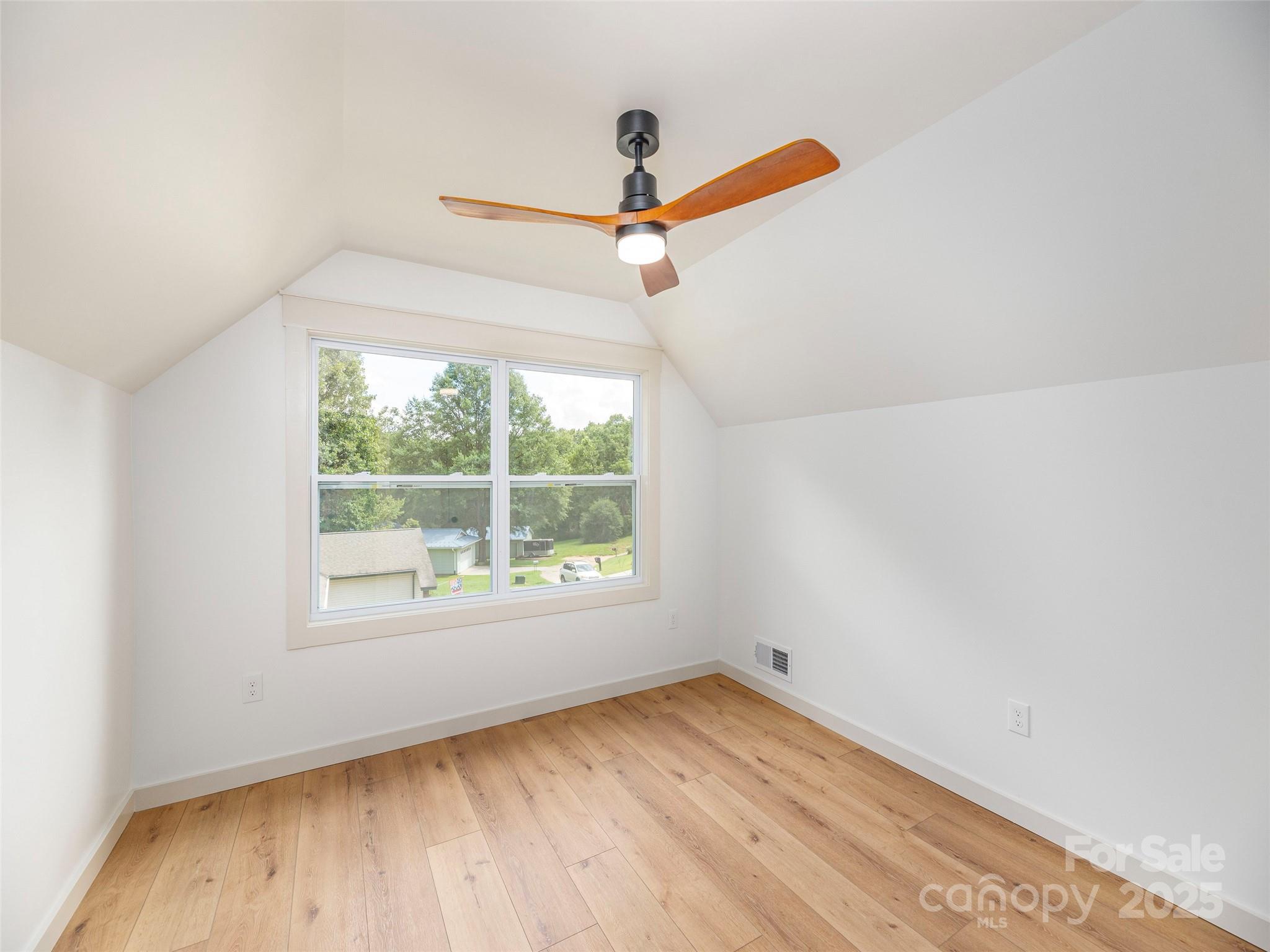 93 Cresthaven Drive Clyde, NC 28721 - Photo 23 of 27 an empty room with a window and a ceiling fan