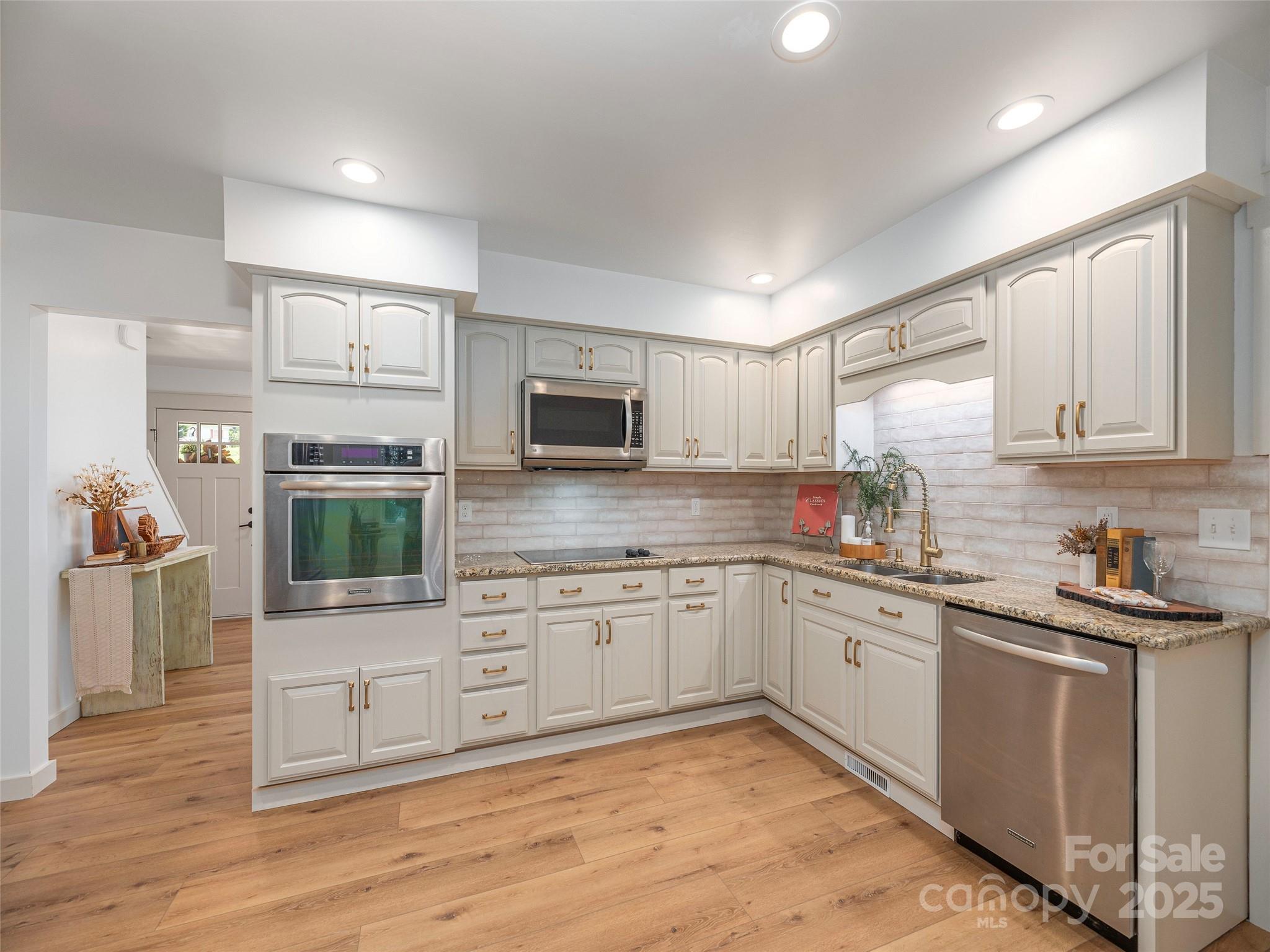 93 Cresthaven Drive Clyde, NC 28721 - Photo 10 of 27 a kitchen with granite countertop cabinets stainless steel appliances a sink and a counter top space