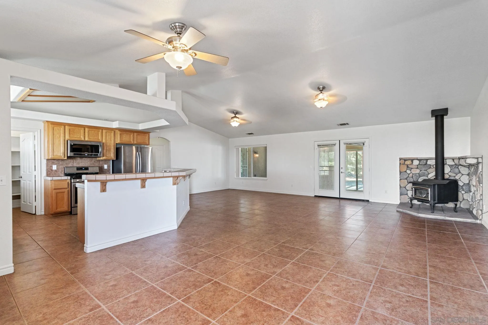 9520 Lebec Road Phelan, CA 92371 - Photo 4 of 27 a view of open kitchen with cabinets and wooden floor