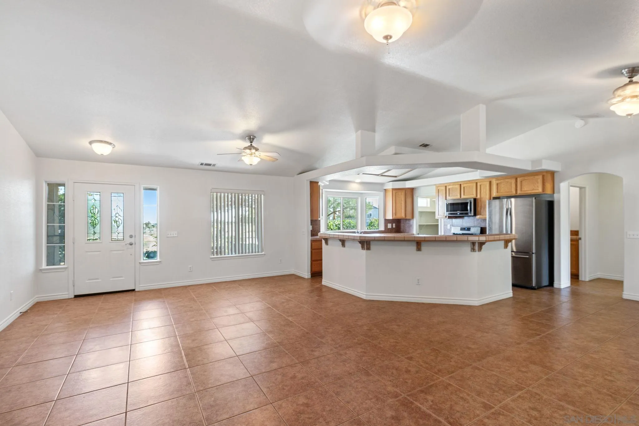 9520 Lebec Road Phelan, CA 92371 - Photo 5 of 27 a view of a living room and kitchen with stainless steel appliances granite countertop cabinets