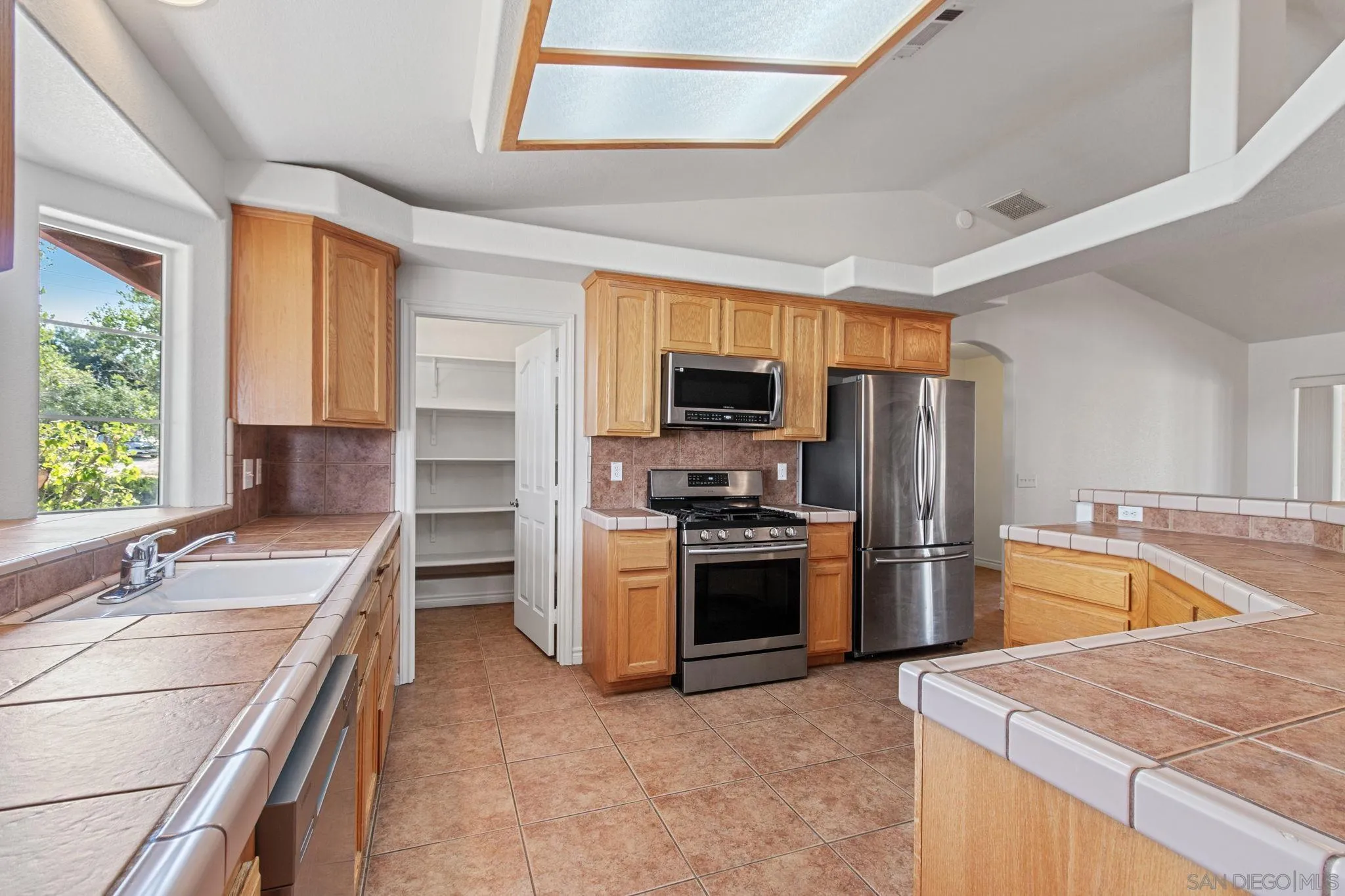 9520 Lebec Road Phelan, CA 92371 - Photo 6 of 27 a kitchen with stainless steel appliances granite countertop a sink stove and refrigerator