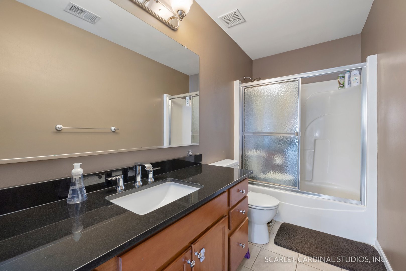 184 Prescott Drive Bartlett, IL 60103 - Photo 17 of 30 a bathroom with a granite countertop sink a toilet a mirror and shower