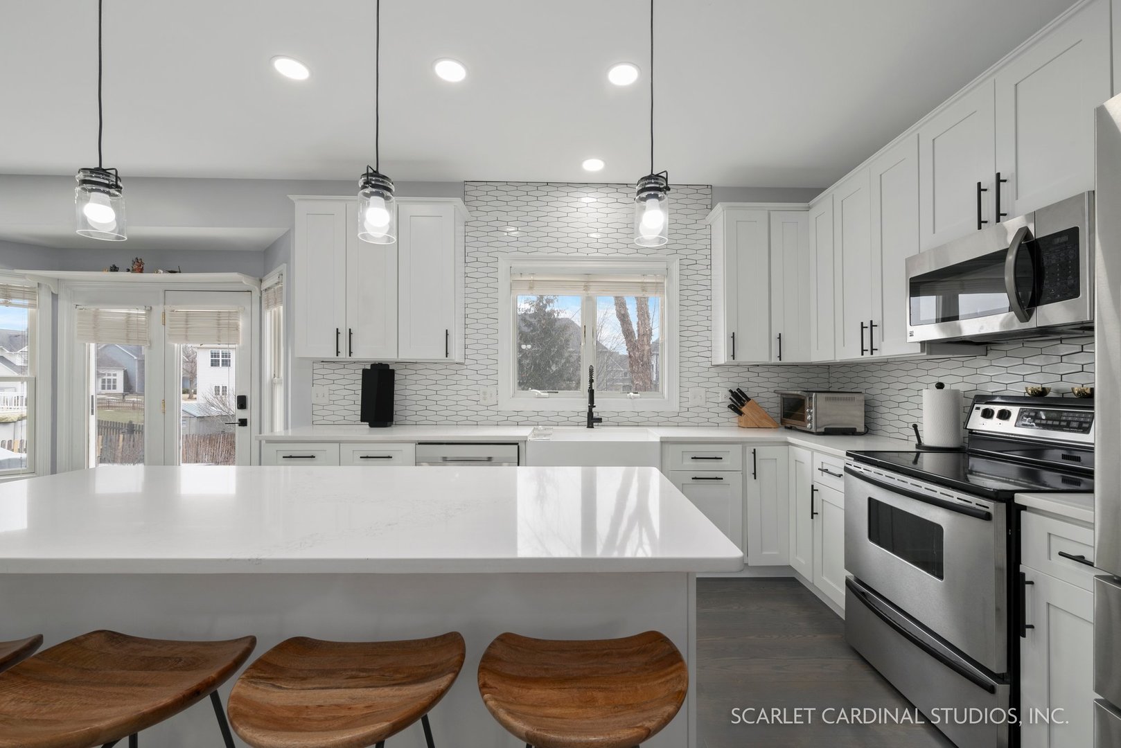 184 Prescott Drive Bartlett, IL 60103 - Photo 6 of 30 a kitchen with a sink a stove a refrigerator and white cabinets
