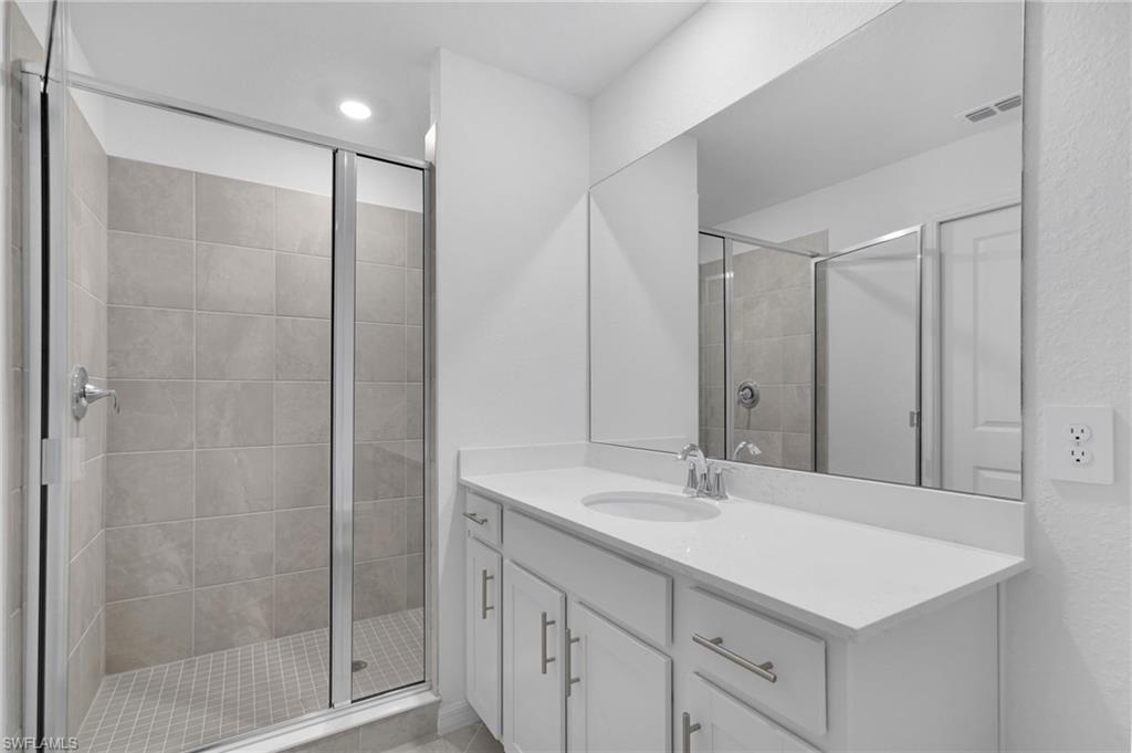 15375 Grn Acrs Avenue, Unit 2227 Babcock Ranch, FL 33982 - Photo 21 of 22 a bathroom with a shower sink and mirror