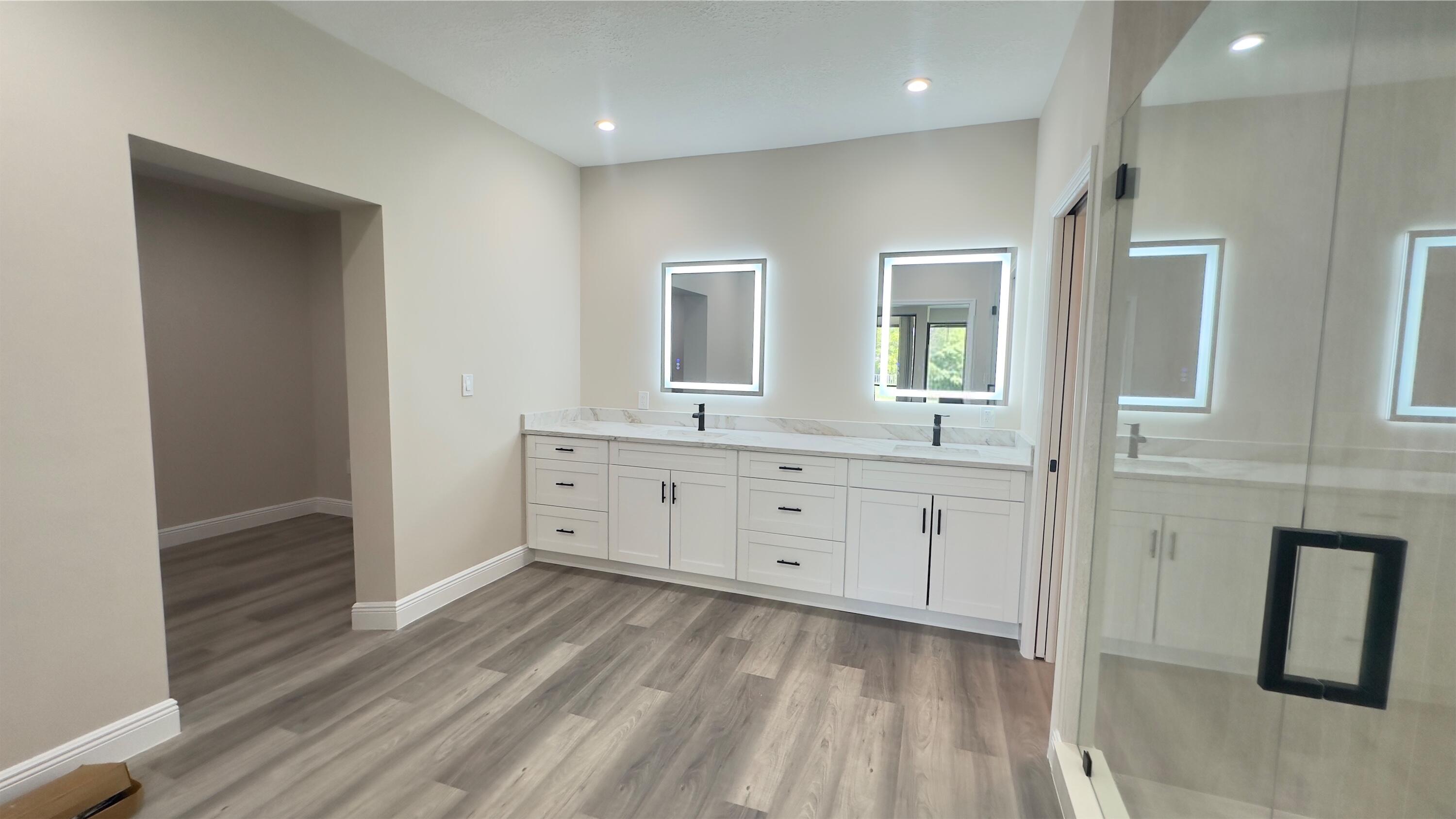 11330 Timber Lodge Terrace Boca Raton, FL 33428 - Photo 17 of 23 a spacious bathroom with a double vanity sink a mirror and shower