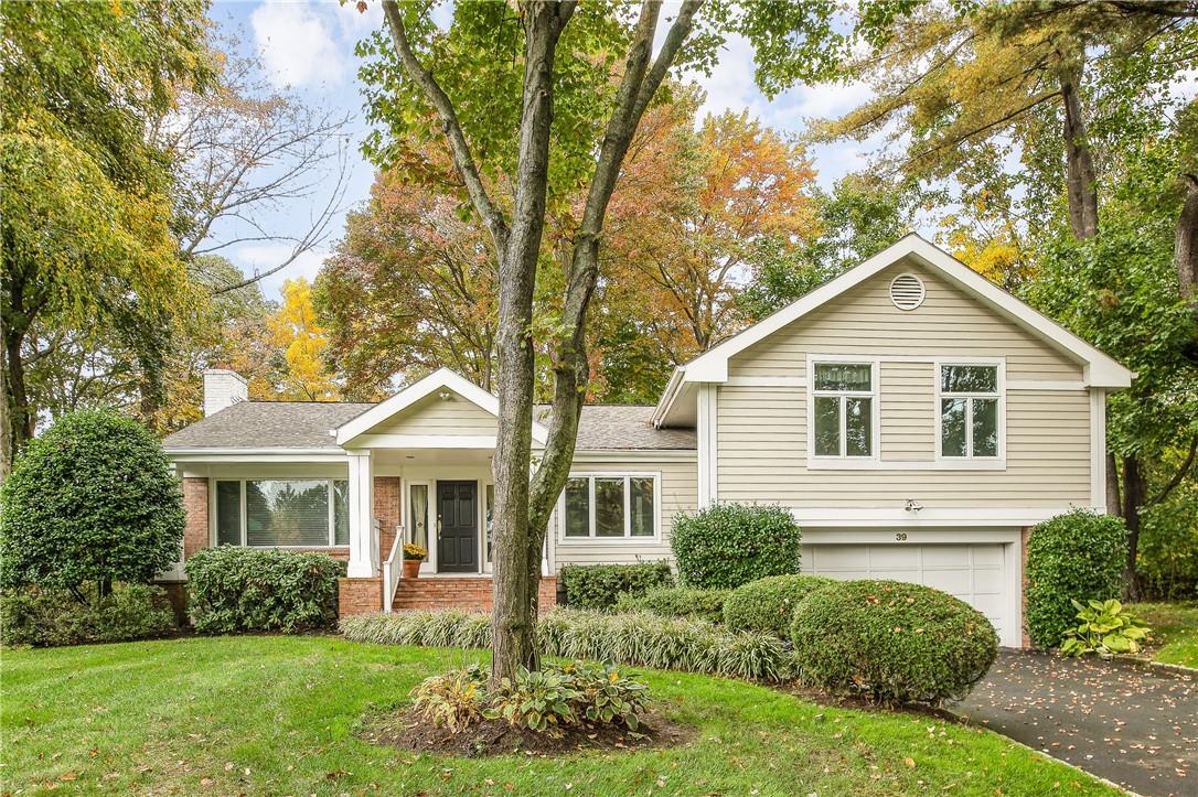 39 Mohegan Lane Rye Brook, NY 10573 - Photo 1 of 1 a front view of a house with a yard and trees