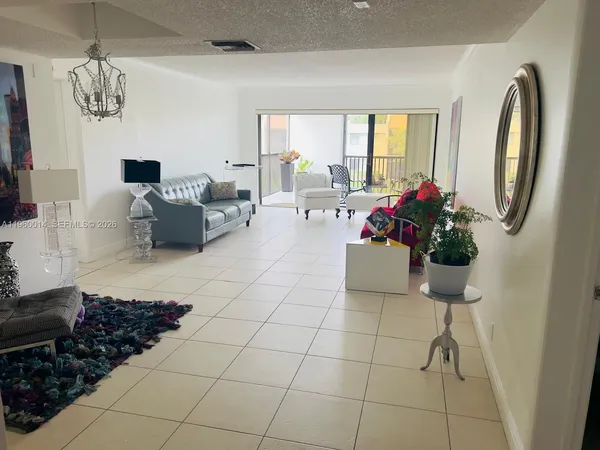 a lobby with furniture and a potted plant