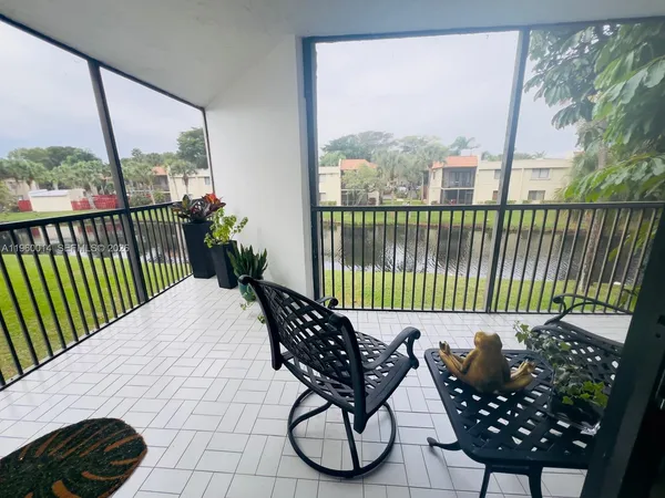 a balcony with table and chairs