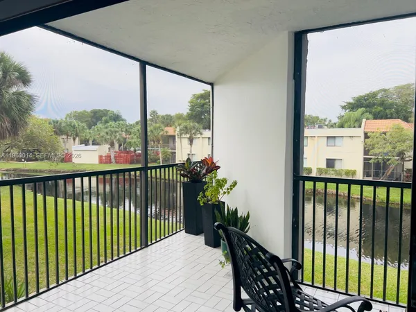 a view of a balcony with wooden floor