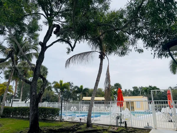 a view of houses with palm trees and yard