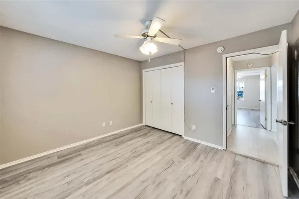a view of an empty room and wooden floor