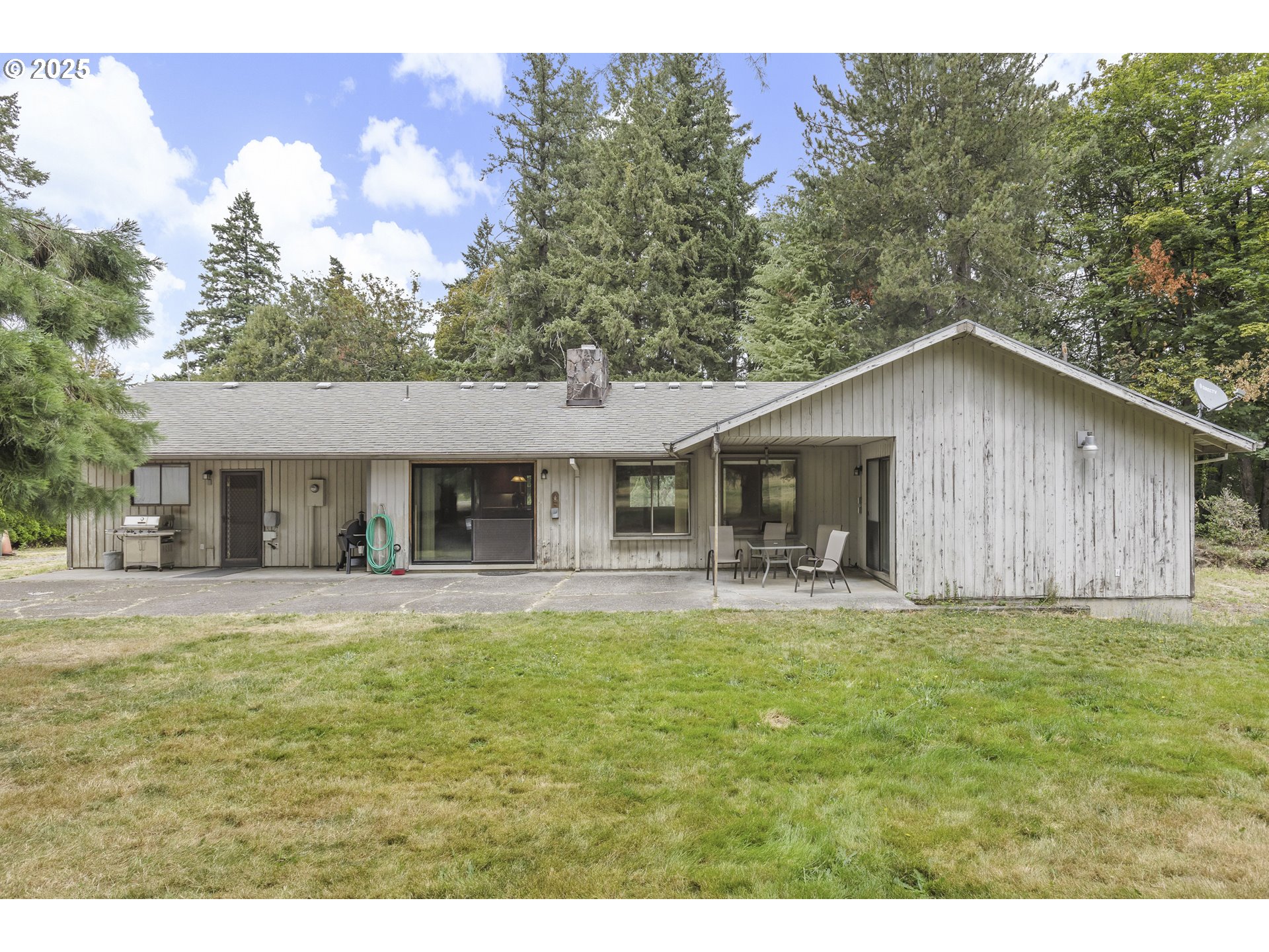 20154 Southeast Foster Road Damascus, OR 97089 - Photo 20 of 40 a big house with a big yard and large trees