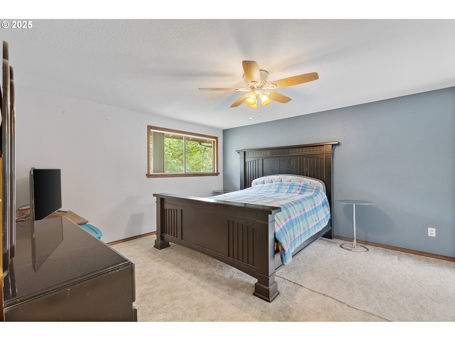 20154 Southeast Foster Road Damascus, OR 97089 - Photo 5 of 40 a bedroom with a bed and a chandelier