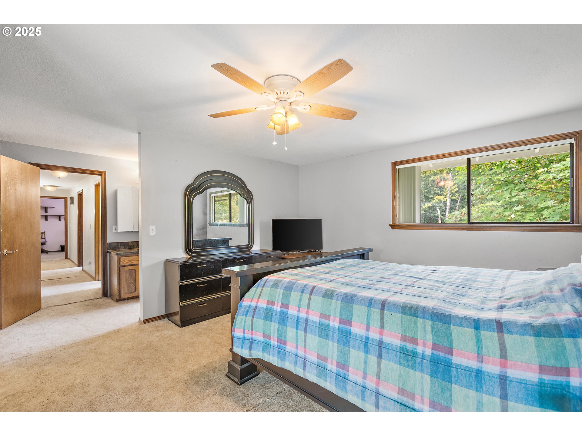 20154 Southeast Foster Road Damascus, OR 97089 - Photo 6 of 40 a bedroom with a bed and a chandelier