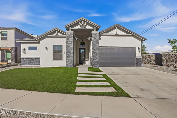 a front view of a house with a yard and garage