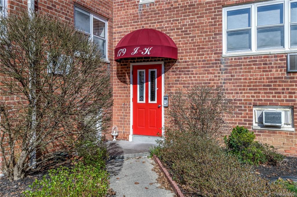 a view of a brick building with a red door