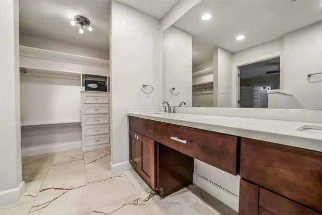 a bathroom with a double vanity sink and a mirror