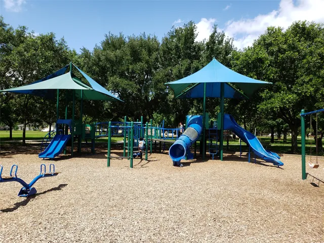 a view of outdoor space with playground and green space