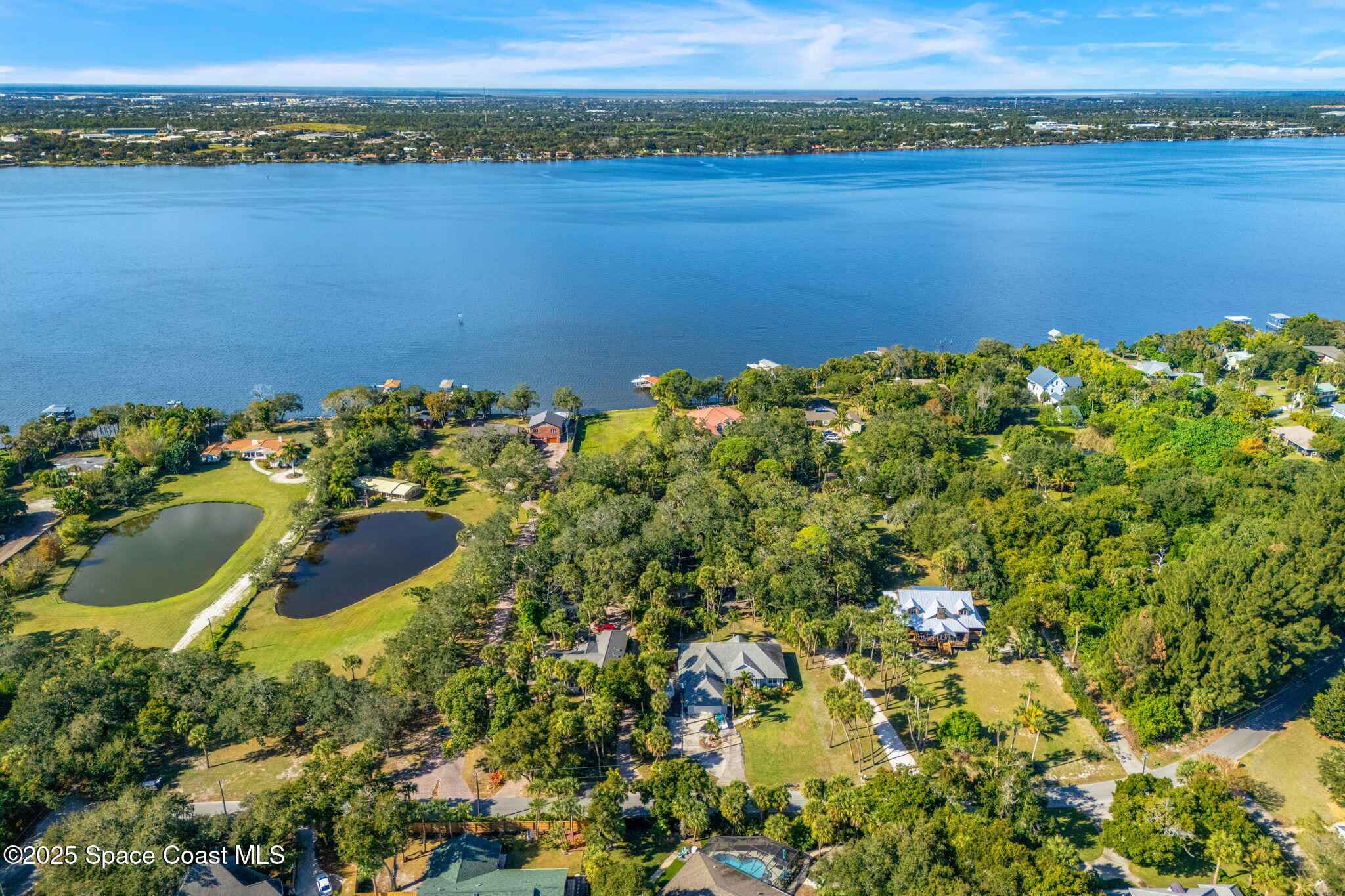 0 Crooked Mile Road Merritt Island, FL 32952 - Photo 13 of 29 an aerial view of a houses with a lake view