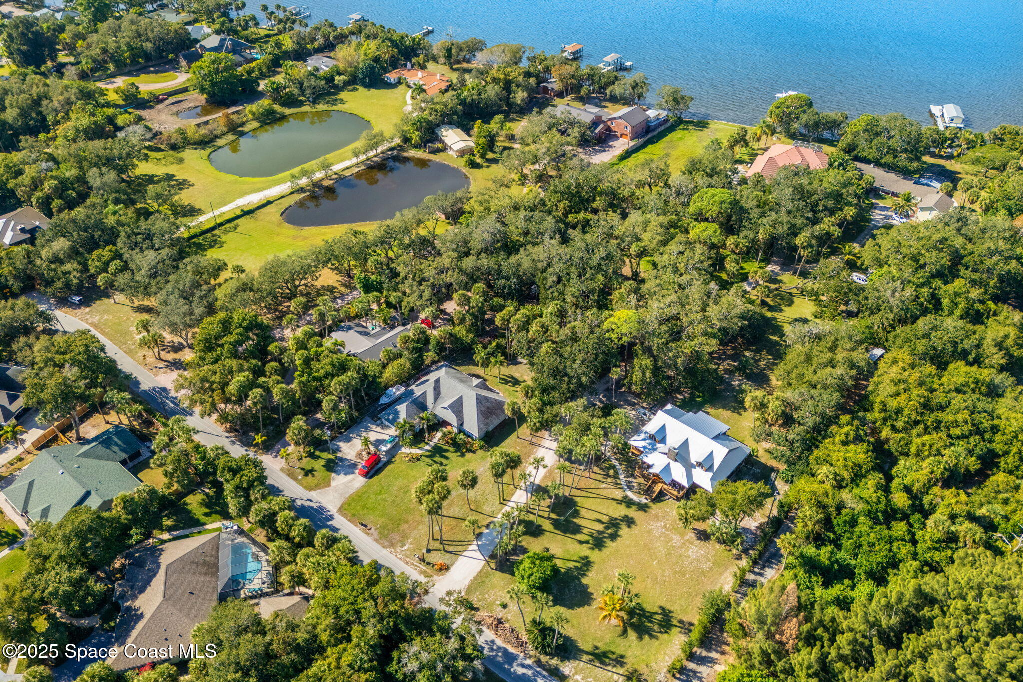 0 Crooked Mile Road Merritt Island, FL 32952 - Photo 2 of 29 an aerial view of residential house with swimming pool and lawn chairs