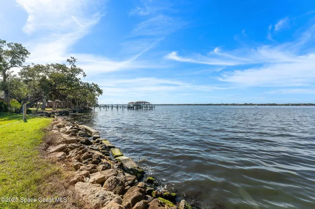 a large body of water with a building in the background