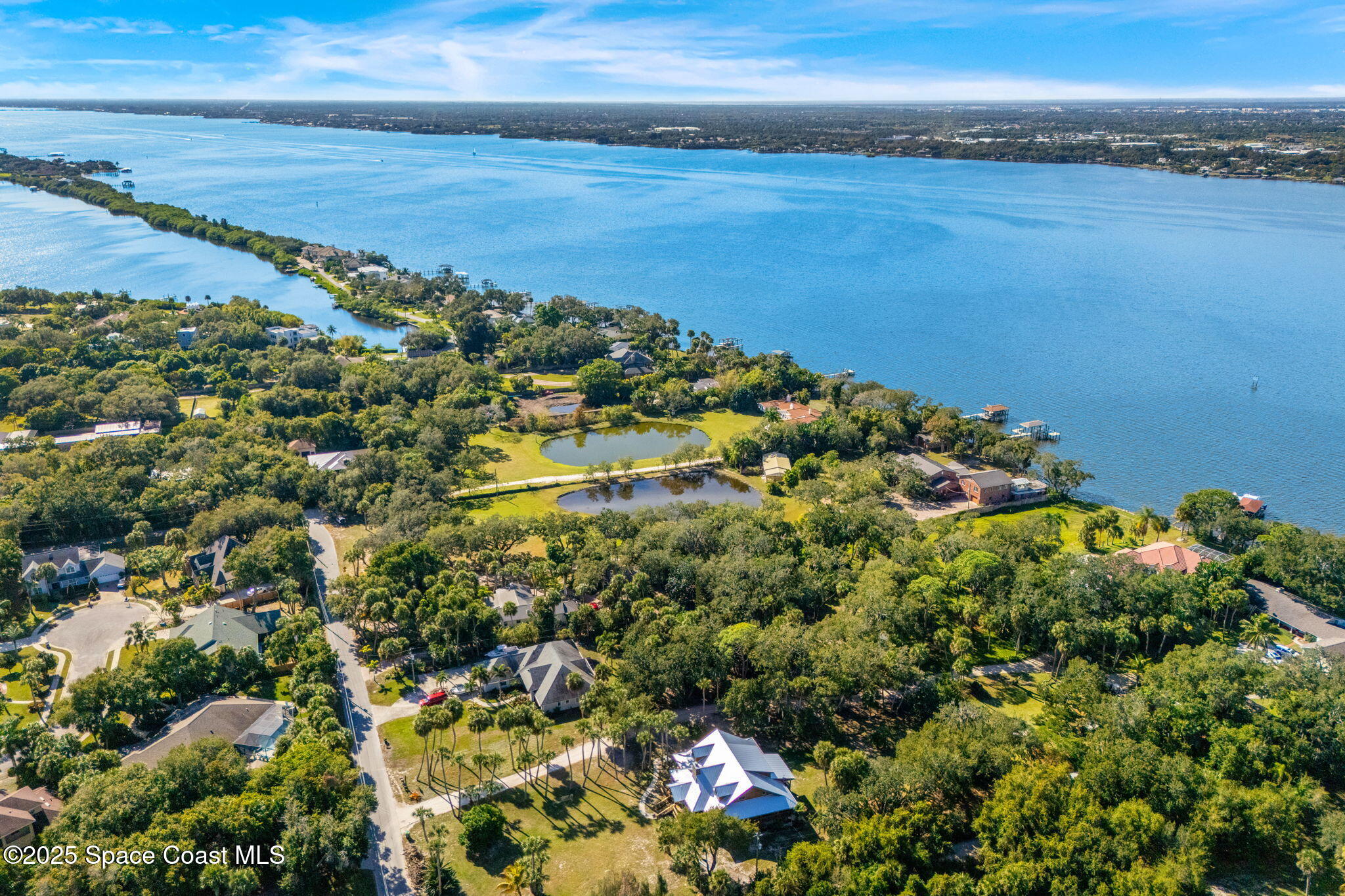 0 Crooked Mile Road Merritt Island, FL 32952 - Photo 9 of 29 a view of a large body of water with a building in the background
