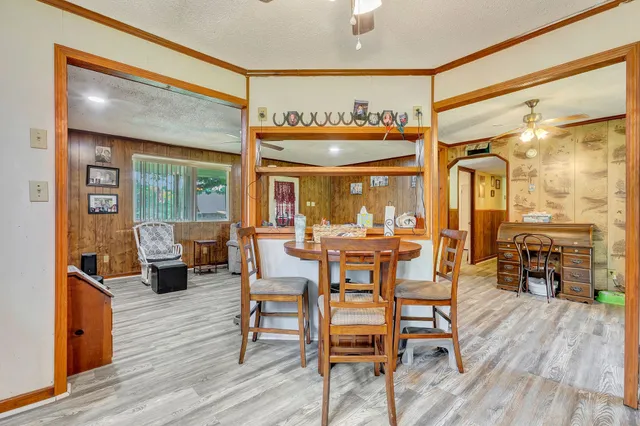a dining room with furniture window and wooden floor