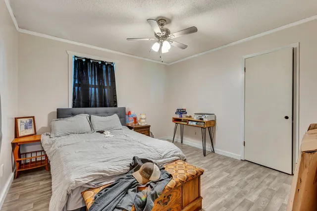 a bedroom with a bed and a chandelier