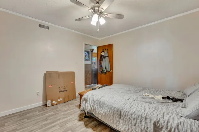 a bedroom with a bed and a chandelier