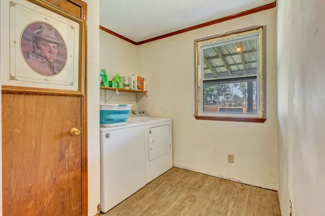 a bedroom with a bed and chandelier