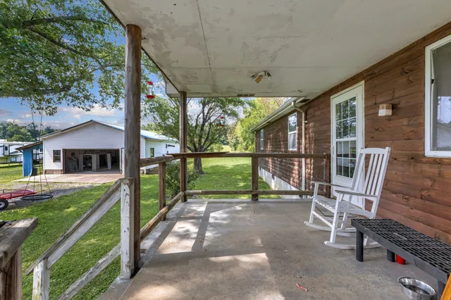 a view of a chair and tables in the backyard