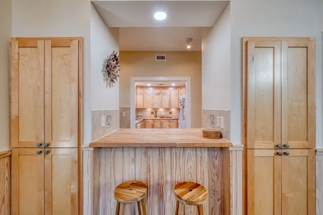 a view of a hallway with furniture and a window