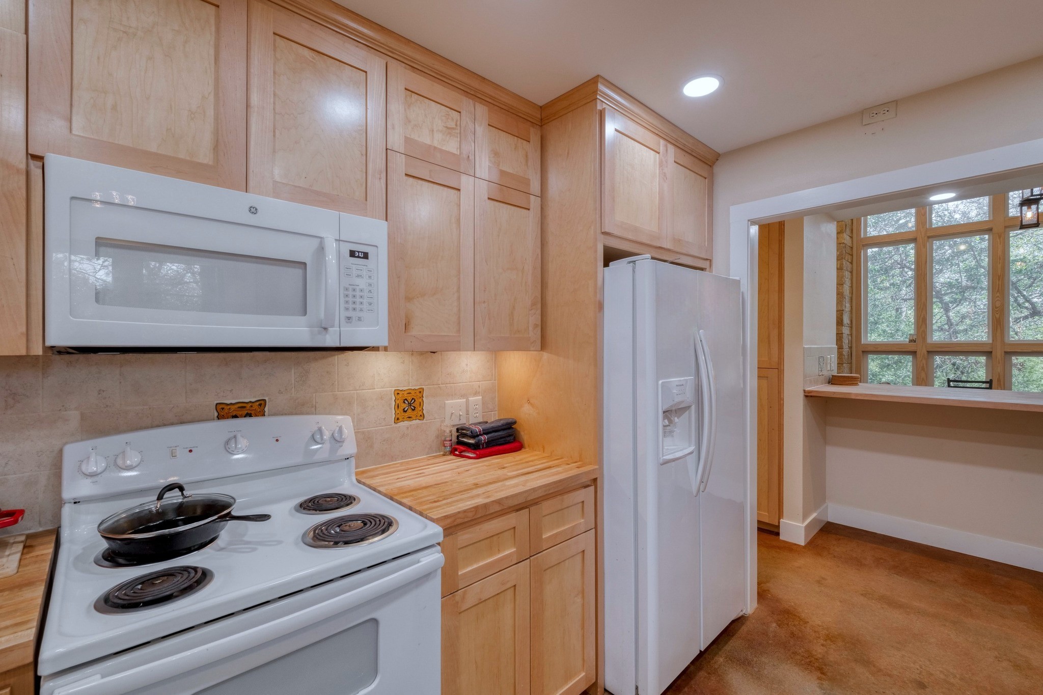 123 Bowie Trail Luling, TX 78648 - Photo 15 of 39 a kitchen with a refrigerator stove and white cabinets