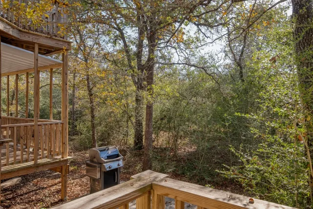 a view of a balcony with chair and wooden fence