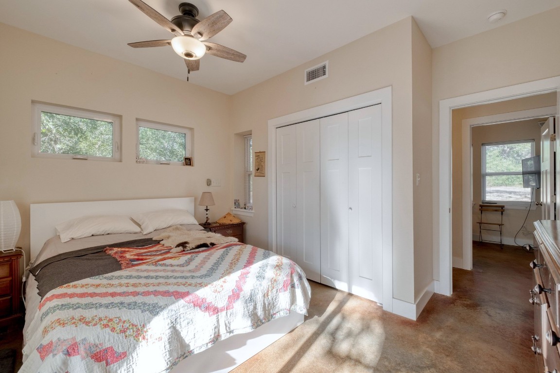 123 Bowie Trail Luling, TX 78648 - Photo 18 of 39 a bedroom with a bed and a chandelier