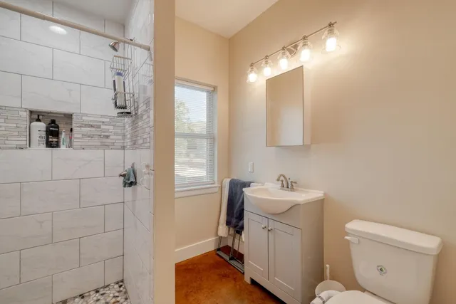 a bathroom with a sink toilet and shower