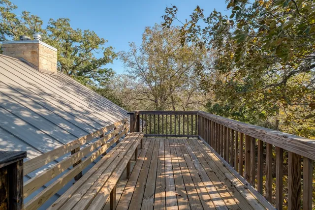 a view of balcony with wooden floor and fence