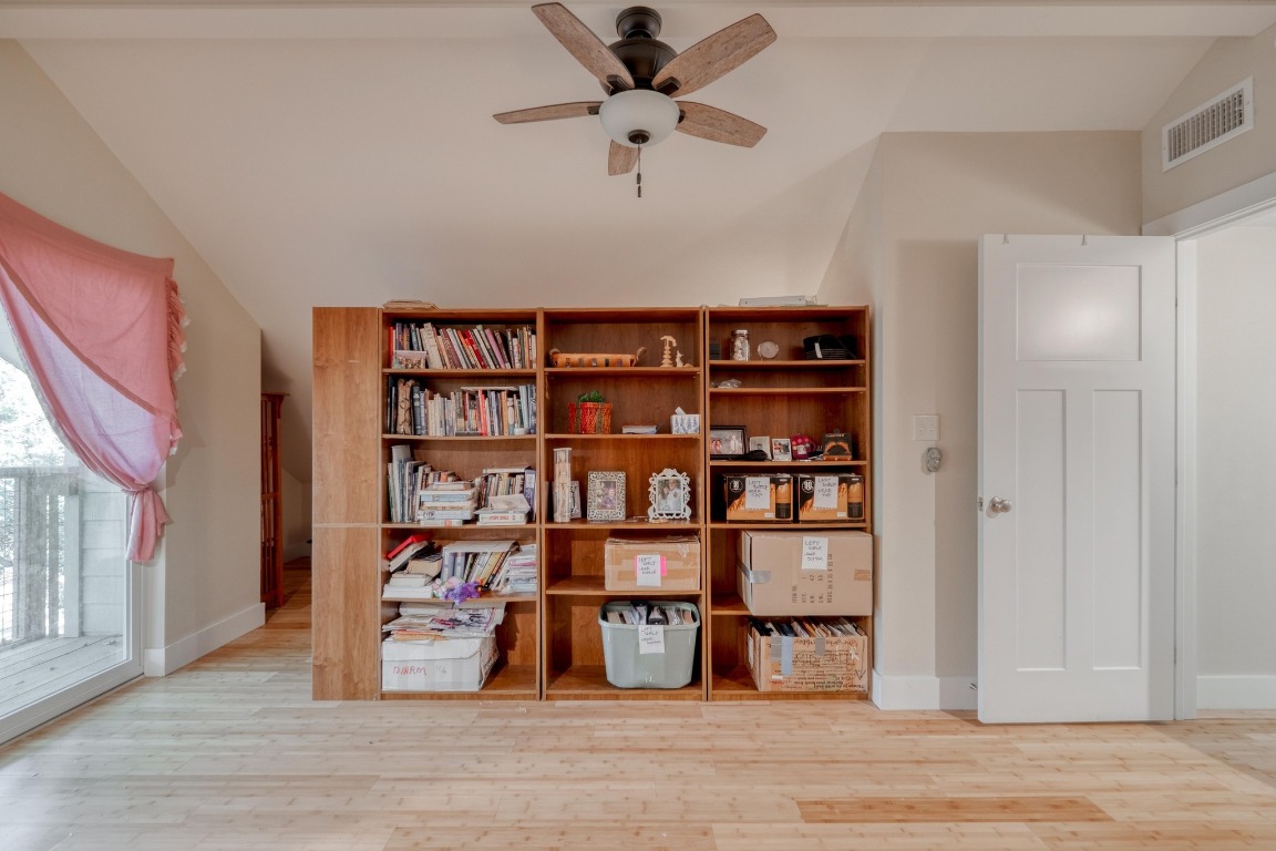 123 Bowie Trail Luling, TX 78648 - Photo 30 of 39 a view of a livingroom with a bookshelf and a book shelf
