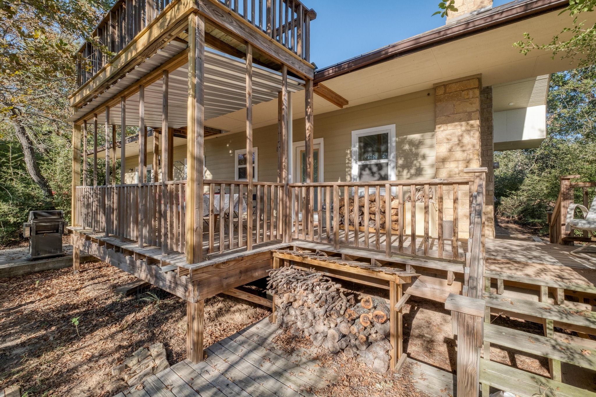 123 Bowie Trail Luling, TX 78648 - Photo 35 of 39 a view of a wooden house with a small yard and wooden fence