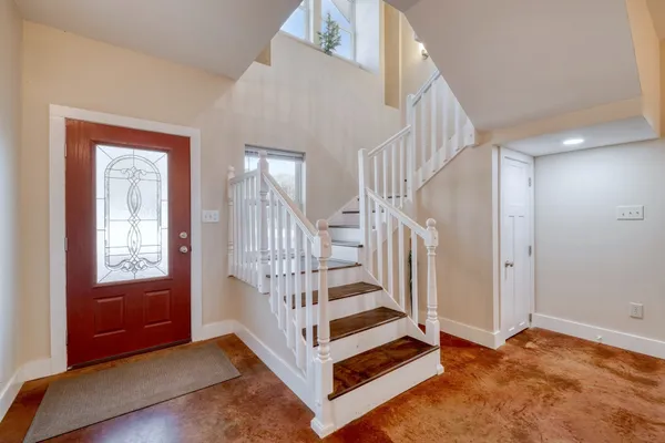 a view of entryway with wooden floor and stairs