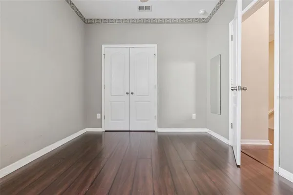 a view of a room with wooden floor
