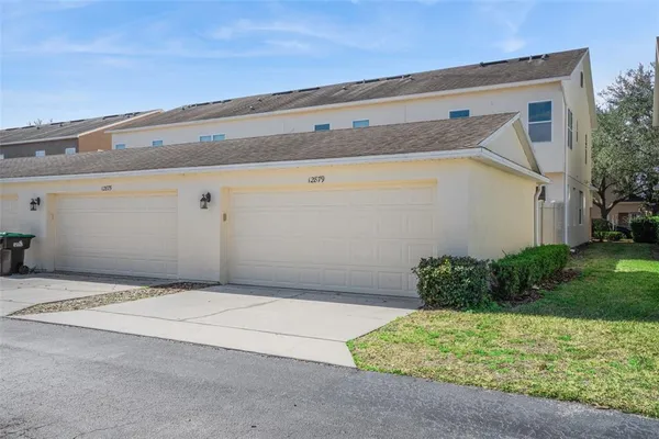 a backyard of a house with lots of green space and plants