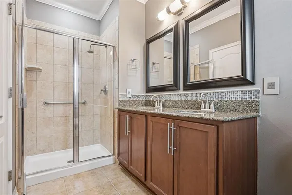 a bathroom with a granite countertop sink mirror and double