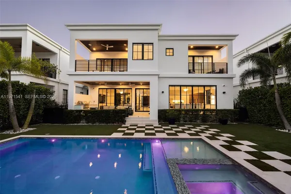 a view of a house with swimming pool and sitting area