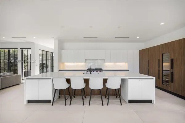 a living room with furniture and large windows